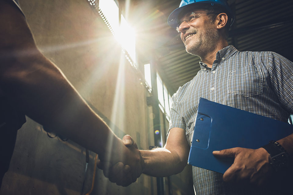 Contractor shaking hands on work site
