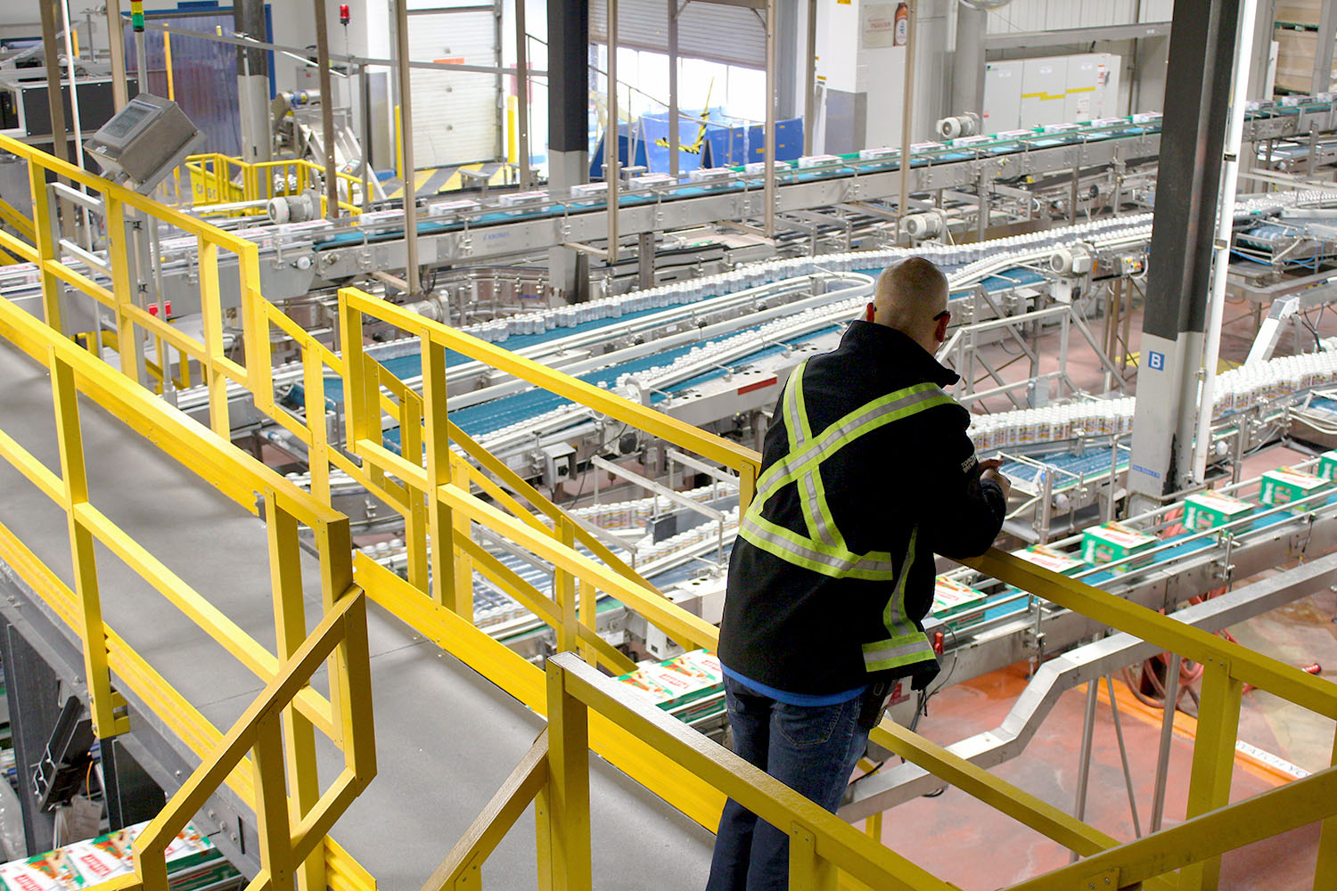 manager overlooking factory floor from catwalk