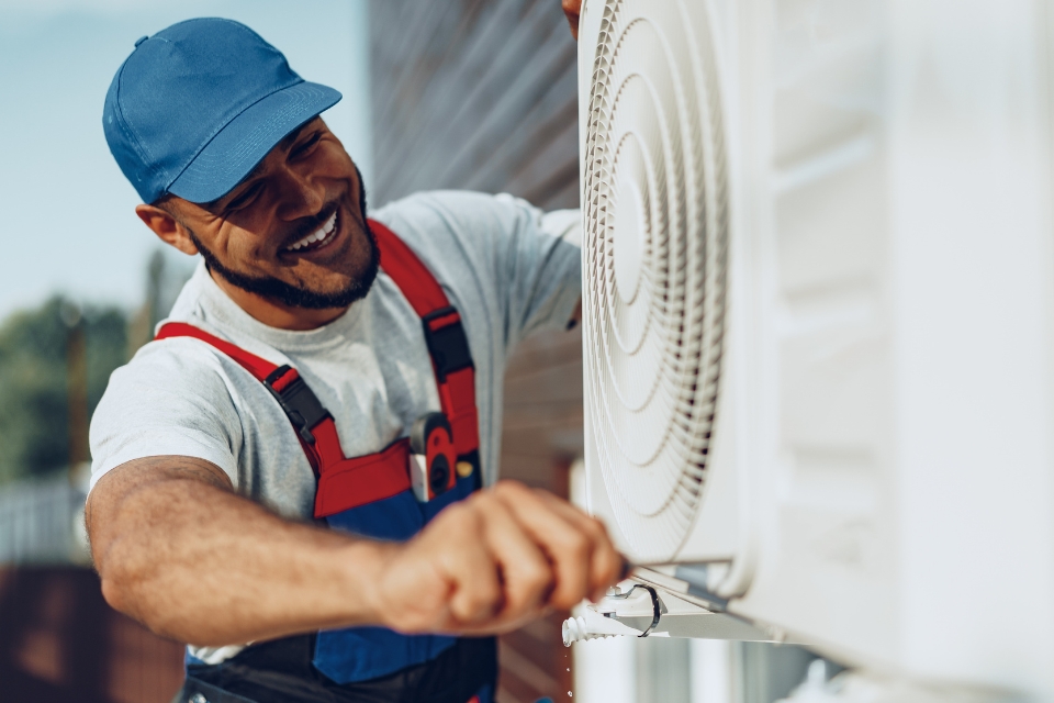 contractor working on a cooling unit