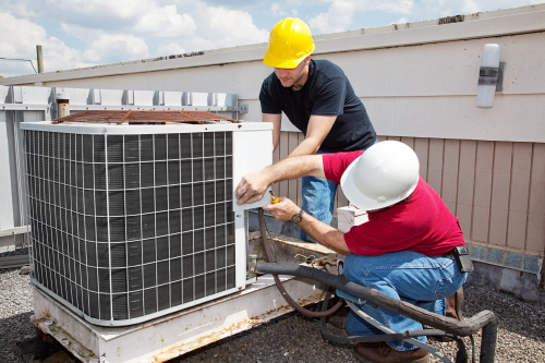 contractors working on commercial cooling unit