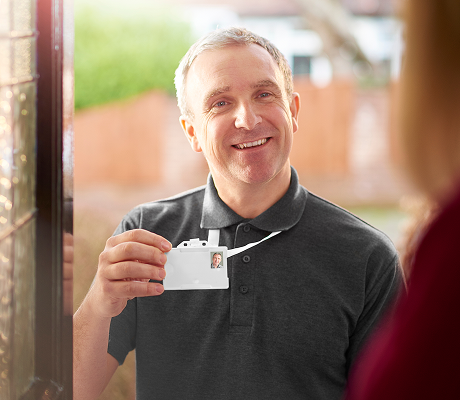 Door to door salesperson showing his ID